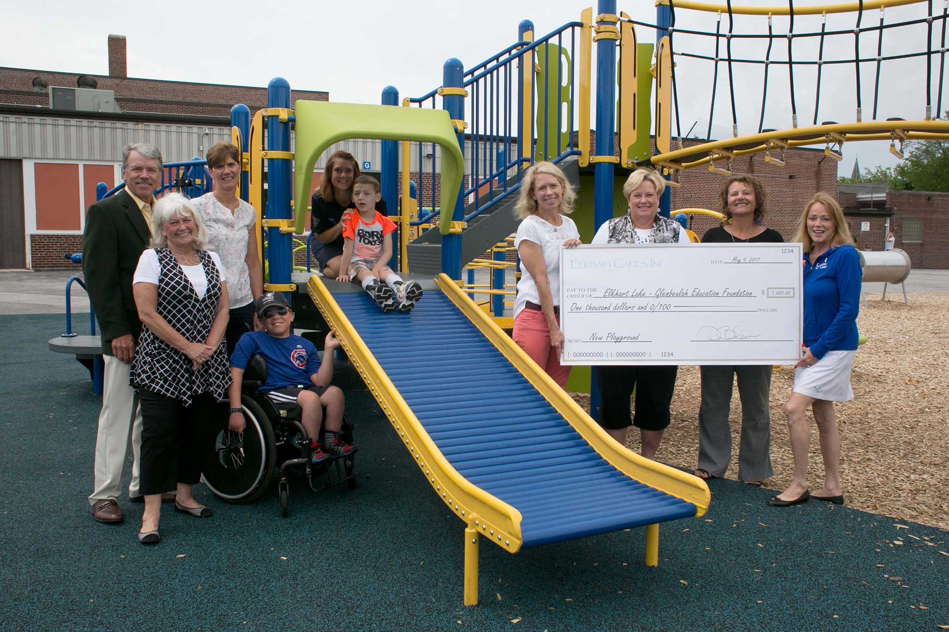 ElkhartCares late founder, Deb Blain, with founding board members presenting a check to sponsor a handicap-accessible playground — ensuring every child has a place to play and belong.